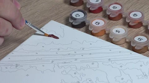 Close-up Shot of Man Doing a Paint-by-Numbers Art Hobby Video stock 317704463