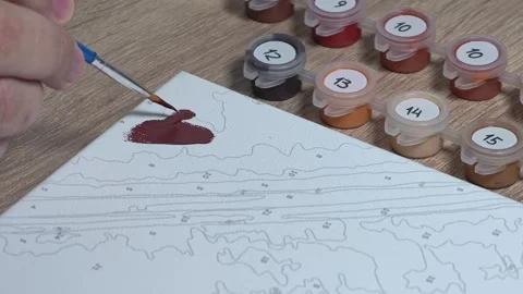 Close-up Shot of Man Doing a Paint-by-Numbers Art Hobby Video stock 317704464