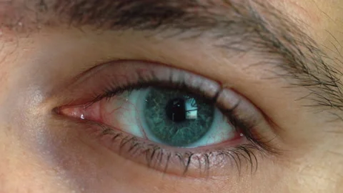 Close up shot of man eye opening with beautiful green and blue iris. Stock Footage 220721291