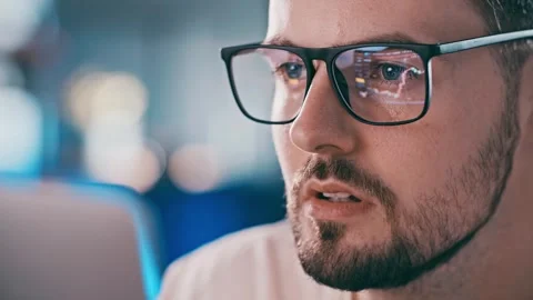 Close up shot of man eyeglasses reflection showing stock market graphic Stock Footage 255424376