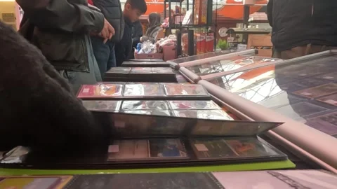 Close Up Shot of Man Flipping Through Pokémon Cards. Stock Footage 300713341