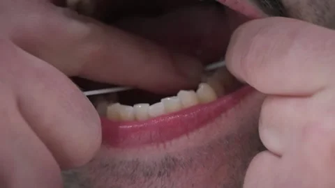 Close up shot of a man flossing his teeth. Stock Footage 314478235