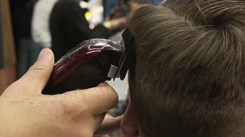 Close up shot of man getting trendy haircut at barber shop. Male hairstylist Stock Footage 154829306