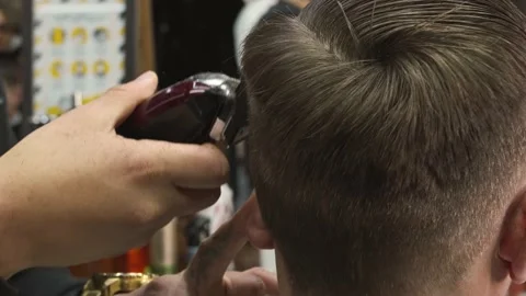 Close up shot of man getting trendy haircut at barber shop. Male hairstylist Stock Footage 156957198