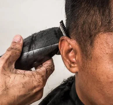 Close up shot of man getting trendy haircut. Male hairstylist serving client, Stock Photos