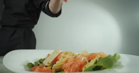 Close up shot of a man hand chef, prepares a salad of seafood and vegetables Stock Footage 168681972