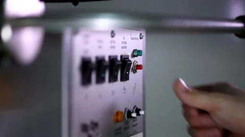 Close up shot of a man hand finger pressing small red button on automatic popcor Stock Footage 137541482