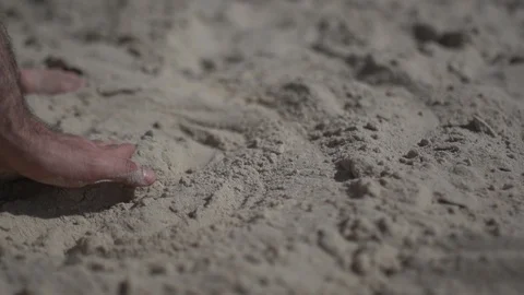 Close up shot on a man hand touching the sand beach. Slow motion real life Stock Footage 100163252