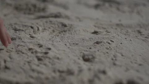 Close up shot on a man hand touching the sand beach. Slow motion real life Stock Footage 100165371