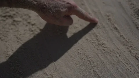 Close up shot on a man hand touching the sand beach. Slow motion real life Stock Footage 100167084