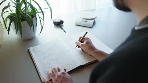 Close up shot of a man hand trying to solve a geometry problem in a Stock Footage 247984217