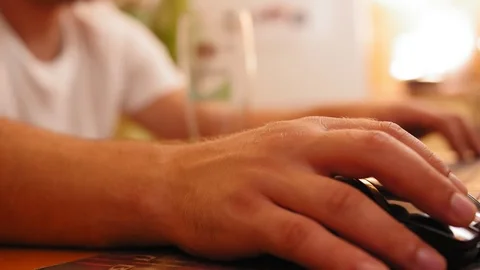 Close up shot of man hand using computer mouse. Working with laptop and drinking Stock Footage 120092119