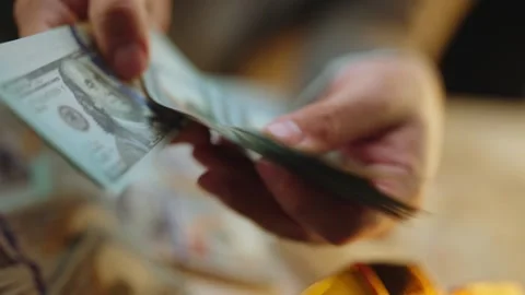 Close up shot of man hands counting stack of hundred dollar bills in slow m.. Stock Footage 337543100