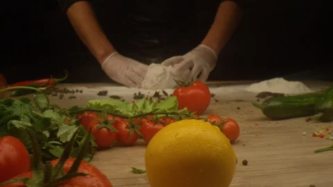 Close up shot of man hands covering fresh chicken fillet with flour Stock Footage 129728043