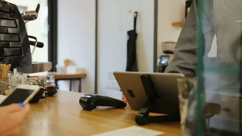 Close up shot of man hands making payment for the coffee by credit card in the Stock Footage 78652382