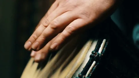 Close up shot of a man hands playing on a Bongo drum. 4k video Video stock 77444461