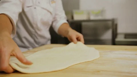 Close up shot of man hands rolling dough to the circle for the bread on the Stock Footage 77888774