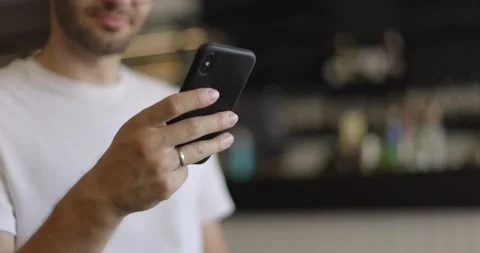Close-up shot of man hands using smartphone at coffee shop. Texting message Stock Footage 164491056