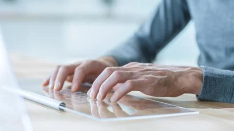 Close-up Shot of a Man Hands Using Transparent  Keyboard of High-Tech Computer Stock Photos