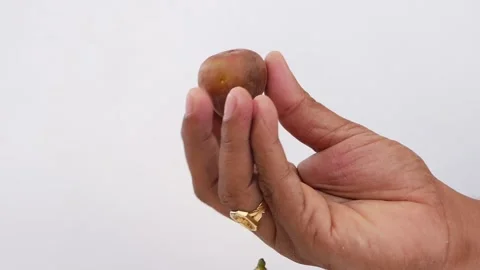 Close shot of a man holding a fig fruit in hand 動画素材 148213327