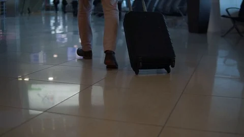 Close up shot of man legs with the baggage walking to the airport terminal. Stock Footage 106200288