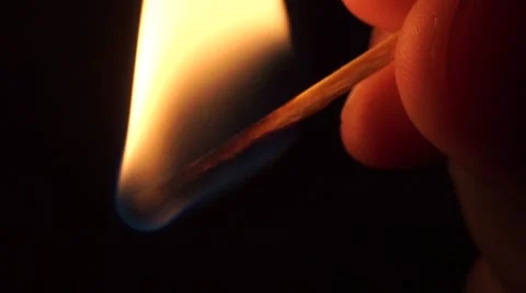 Close up shot of man lighting up a match in the dark Stock Footage 57313845