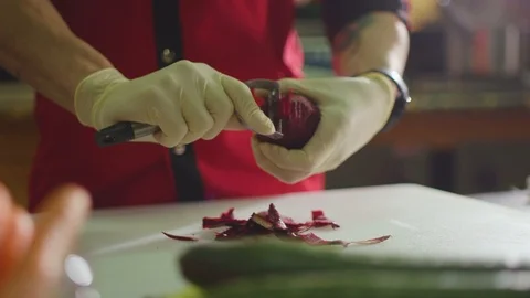 Close up shot of man peeling a beet Stock Footage 119300152
