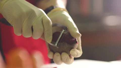 Close up shot of man peeling a beet Stock Footage 119300186