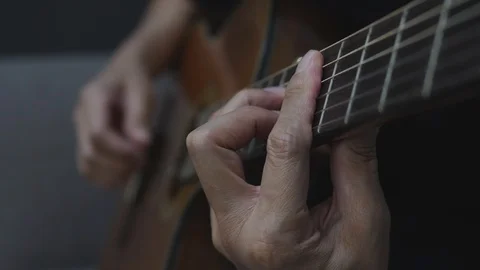 Close-up shot of a man playing a classical guitar. Stock Footage 127330799
