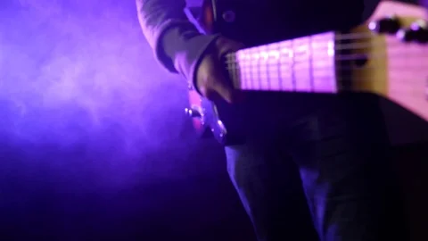 This is a close up shot of a man playing a guitar 動画素材 71083633