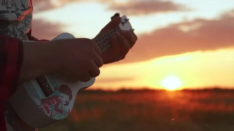 Close shot of man playing guitar ukulele Stock Footage 78736298