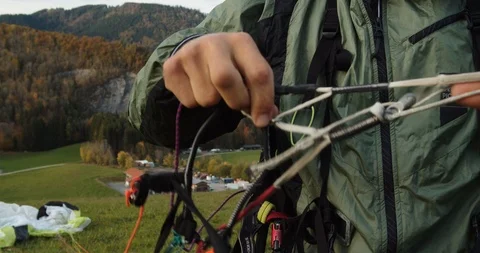 Close up shot, a man preparing the cables of the paraglider. Stock Footage 122922790