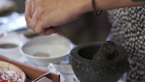 Close up shot of A man is put  Asian ingredients to a mortar  Stock Footage 146250164