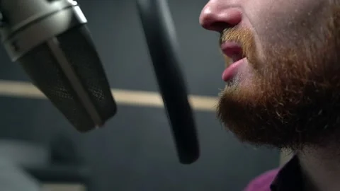 Close shot of man with red beard face, fast broadcast text with microphone Stock Footage 154347306