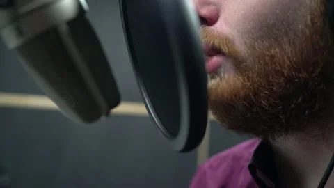 Close shot of man with red beard face, fast broadcast text with microphone Stock Footage 154370443