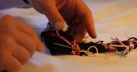 Close shot of man sewing with wool thread, traditional hand work Video stock 120040035