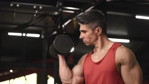 Close up shot of man soing forearms workout using dumbbells at gym Stock Footage 201407011