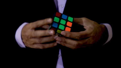 Close shot of a man solving Rubik's Cube. Stock Footage 120578116