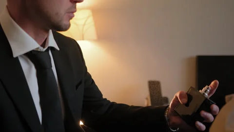 Close up shot of man splits the perfume on himself. Slow motion view Stock Footage 274359703