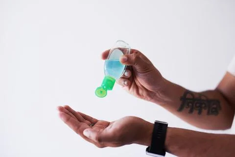 A close up shot of a man squeezing hand sanitiser into his palm Foto stock
