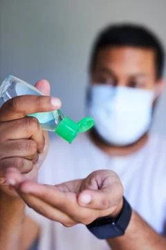 A close up shot of a man squeezing hand sanitiser into his palm Stock Photos