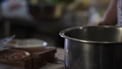 Close up shot of Man stirring The Broth  in a stainless steel pot. Stock Footage 146250102