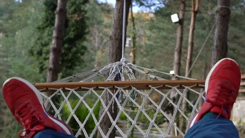 Close up shot of a man swinging on hammock Stock Footage 80930985