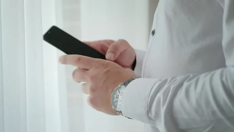 Close up shot of a man taking his smartphone and check out messages. 動画素材 138681968