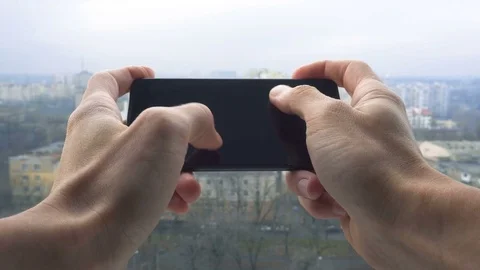 Close-up shot of man texting on smart phone against cityscape Stock Footage 83428251
