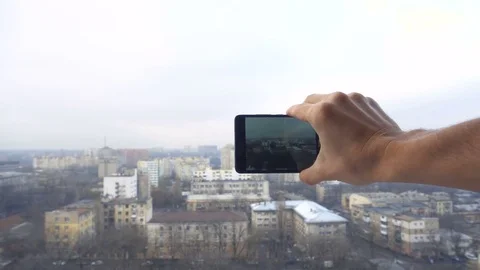 Close-up shot of man texting on smart phone against cityscape Stock Footage 83428480