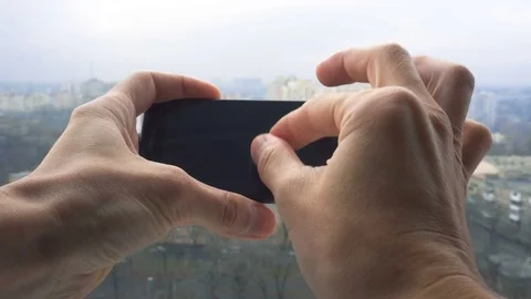 Close-up shot of man texting on smart phone against cityscape Video stock 83531347