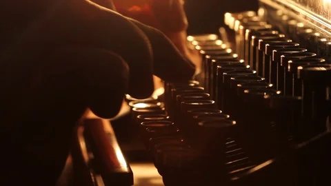 Close up shot of man typing on old vintage retro typewriter; backlit Stock Footage 117852461