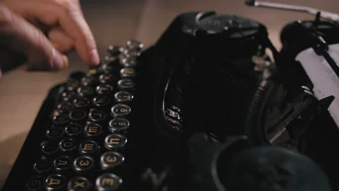 Close up shot of man typing on old vintage retro typewriter; backlit; news Stock Footage