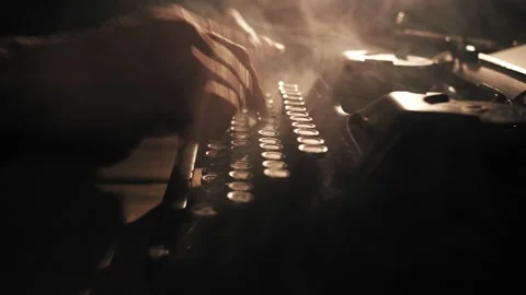 Close up shot of man typing on old vintage retro typewriter; backlit; news Vidéo 134598416